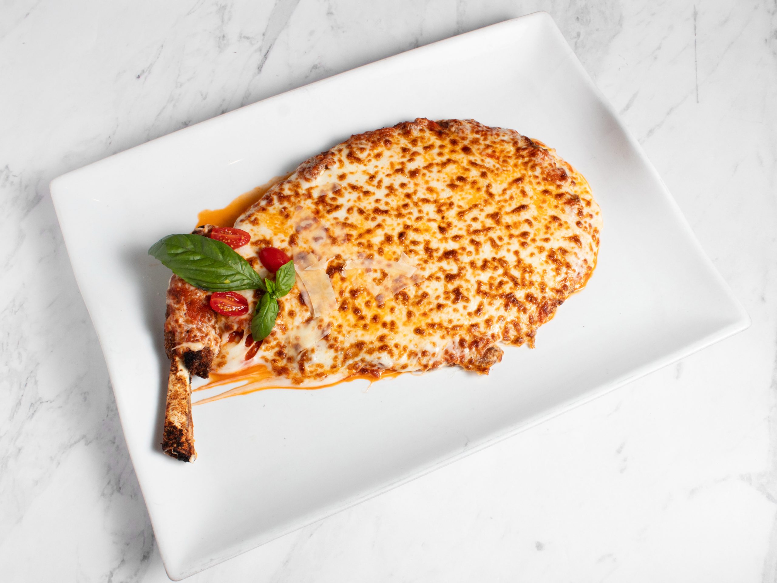 Veal Chop Parmigiana - Breaded veal with marinara